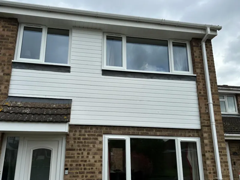 Semi-detached house with newly installed white windows and front door