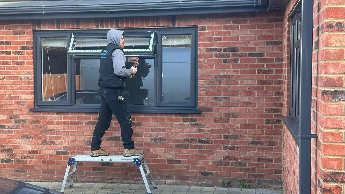 L.D.M Installation fitter on a step fitting an anthracite grey window